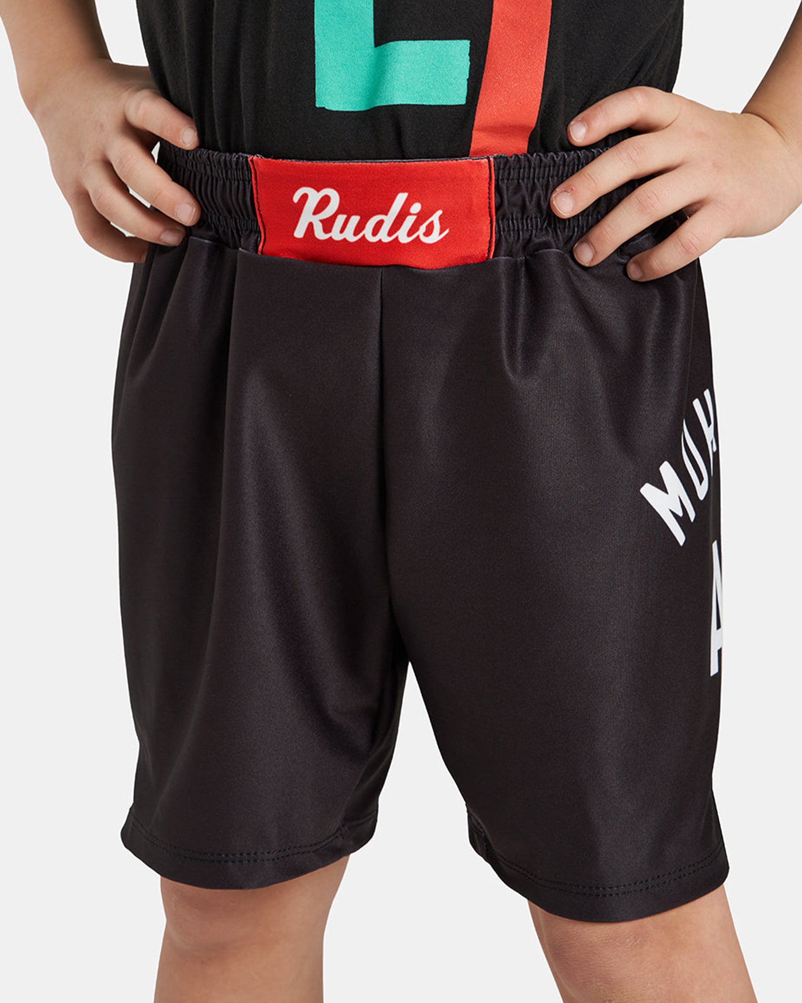 Black athletic shorts with a red waistband featuring the brand name Rudis and white graphics