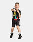 A young boy in a colorful shirt and black shorts strikes a boxing pose with a playful smile showcasing his athletic spirit