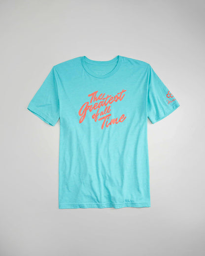 A light blue t-shirt featuring the phrase The Greatest of All Time in bold coral lettering designed for casual wear