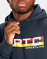 A close-up view of a person wearing a navy blue hoodie with a bold RTC WRESTLING graphic designed in vibrant colors