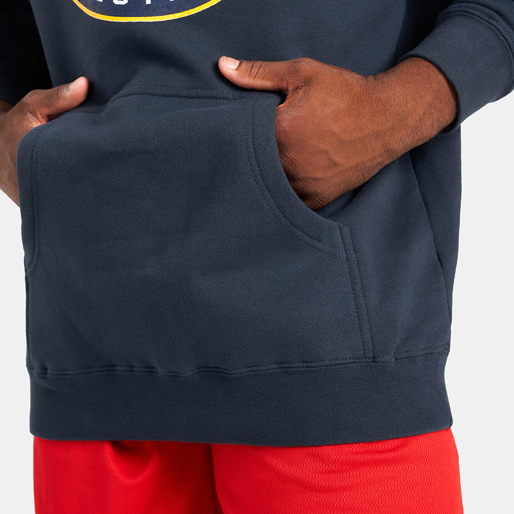 A close-up view of a person wearing a dark navy hoodie with a front pocket complemented by bright red shorts showcasing a casual and sporty ensemble