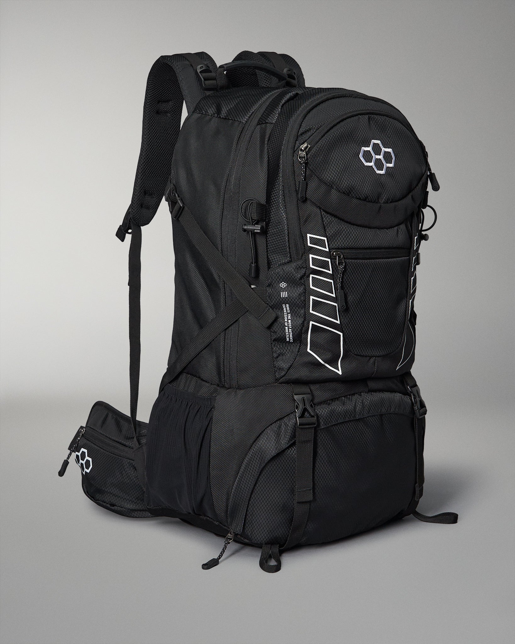 A sleek black backpack with multiple compartments and adjustable padded straps features white accents and a logo, set against a gray background.