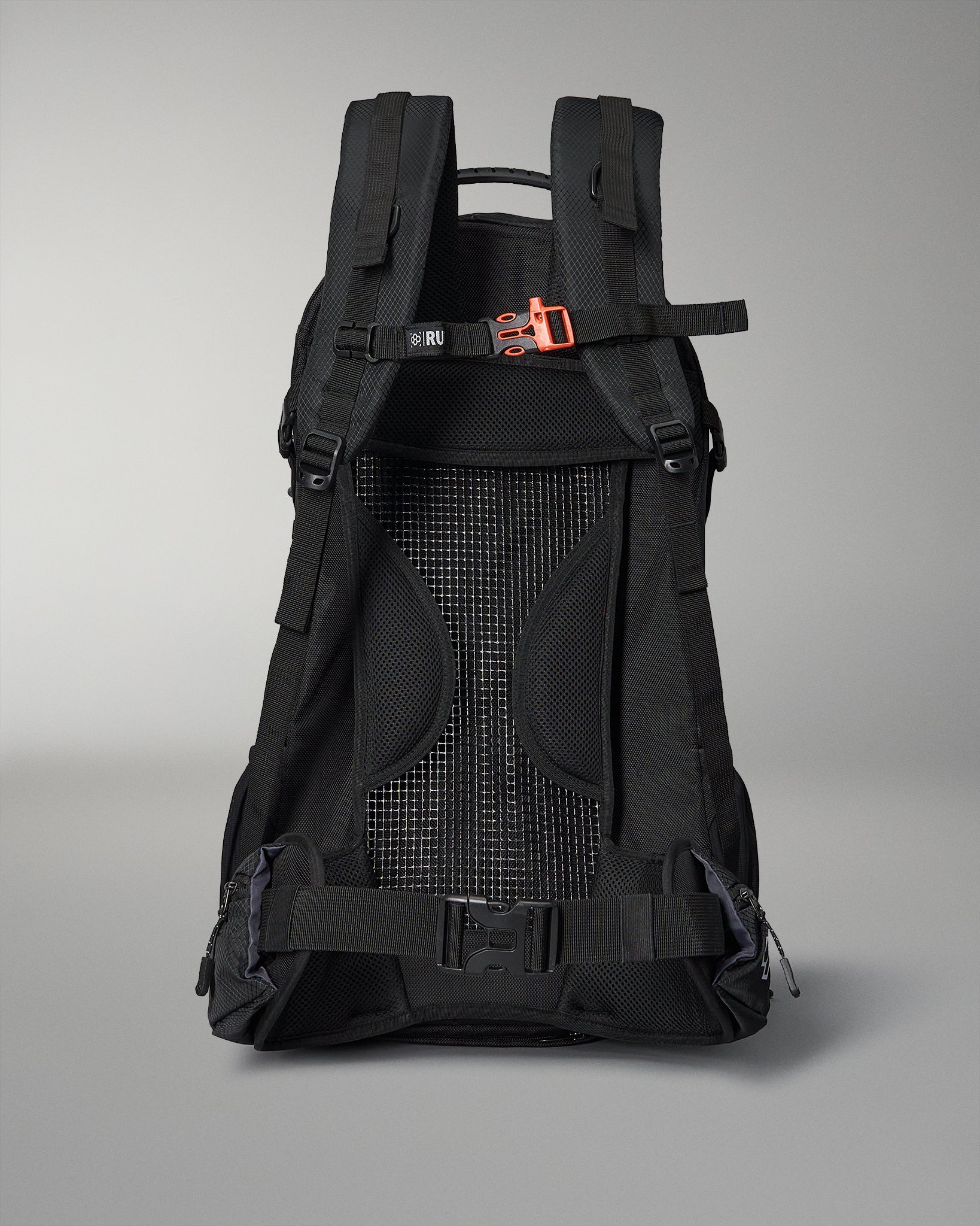 A black ergonomic backpack with adjustable straps and a breathable mesh back for ventilation, highlighted by an orange buckle detail and side zippers for easy access.