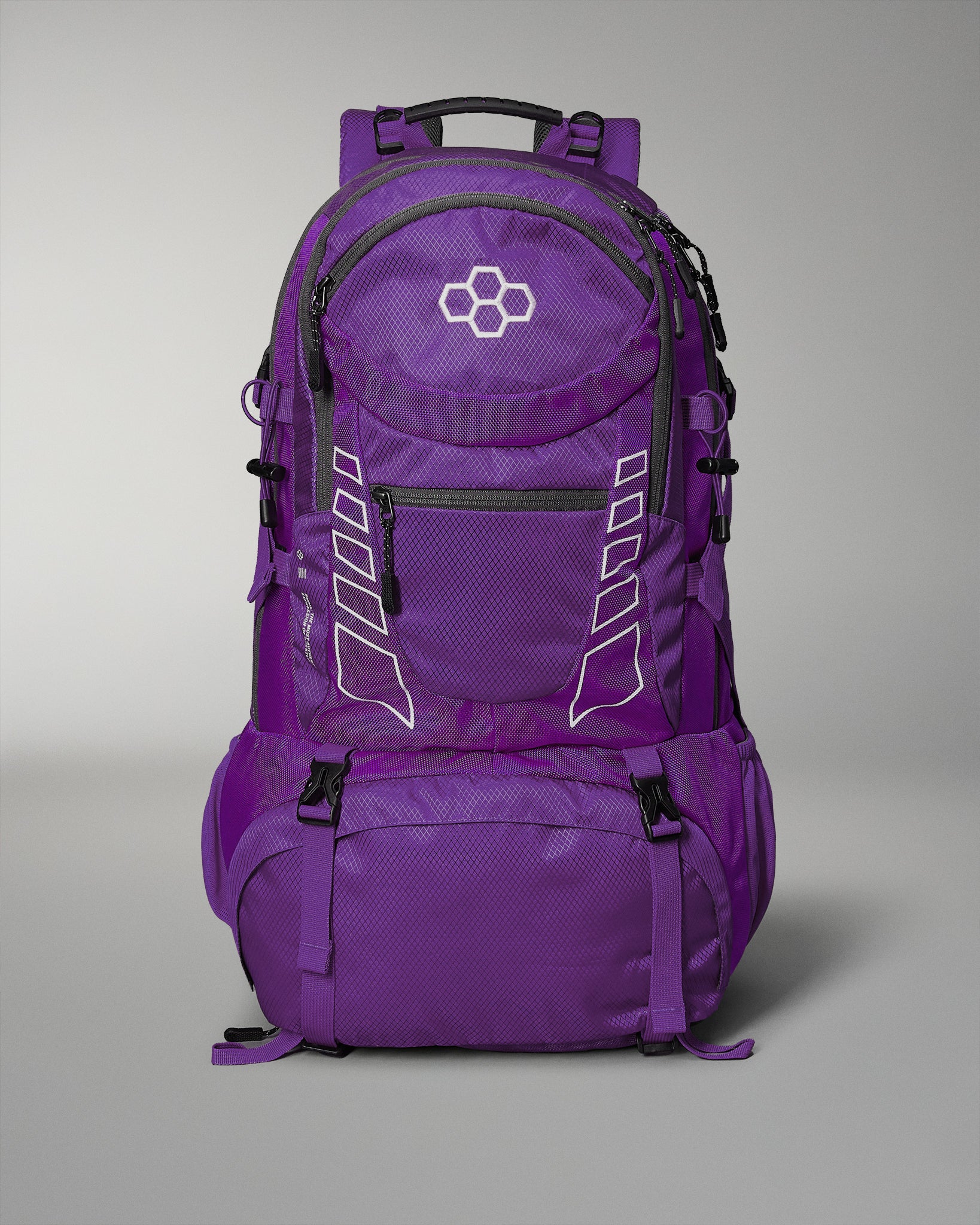 A vibrant purple backpack with a hexagonal logo, featuring multiple compartments for organized storage and adjustable side straps against a soft gray background.