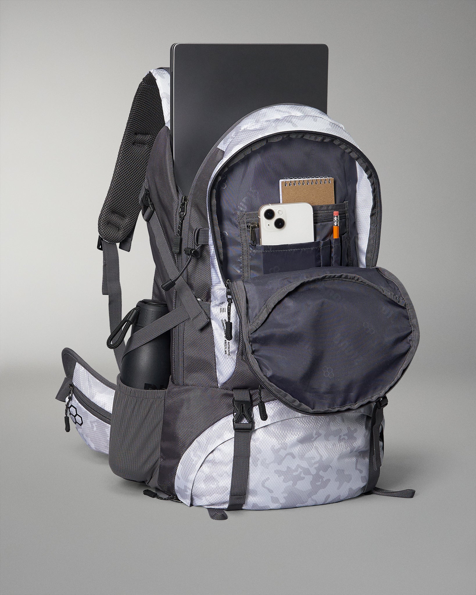 A modern gray and black backpack featuring various compartments including a laptop sleeve phone pocket and a water bottle holder designed for versatility and convenience