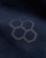 A close-up view of a navy fabric featuring a subtle hexagonal logo design emphasizing texture and branding