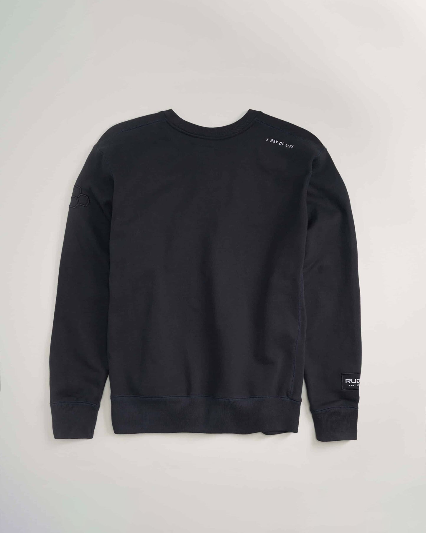 This image showcases a black sweatshirt featuring a modern design with subtle text and branding elements on the sleeves