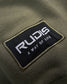 The image presents a close-up view of a clothing label featuring the brand name RUDIS highlighted with the tagline A WAY OF LIFE