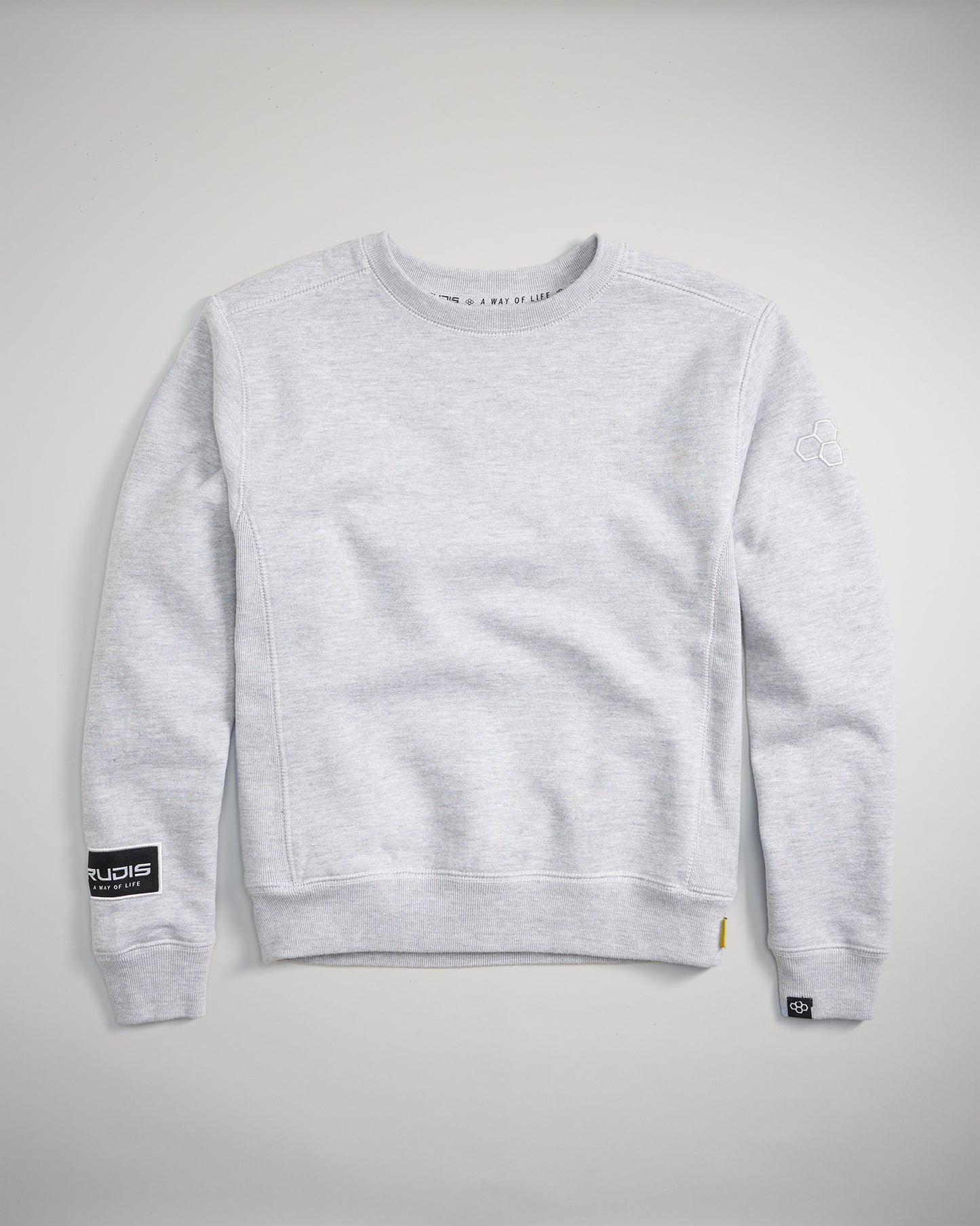 A light gray crewneck sweatshirt featuring a minimalistic design ribbed cuffs and hem and logo accents on the sleeves