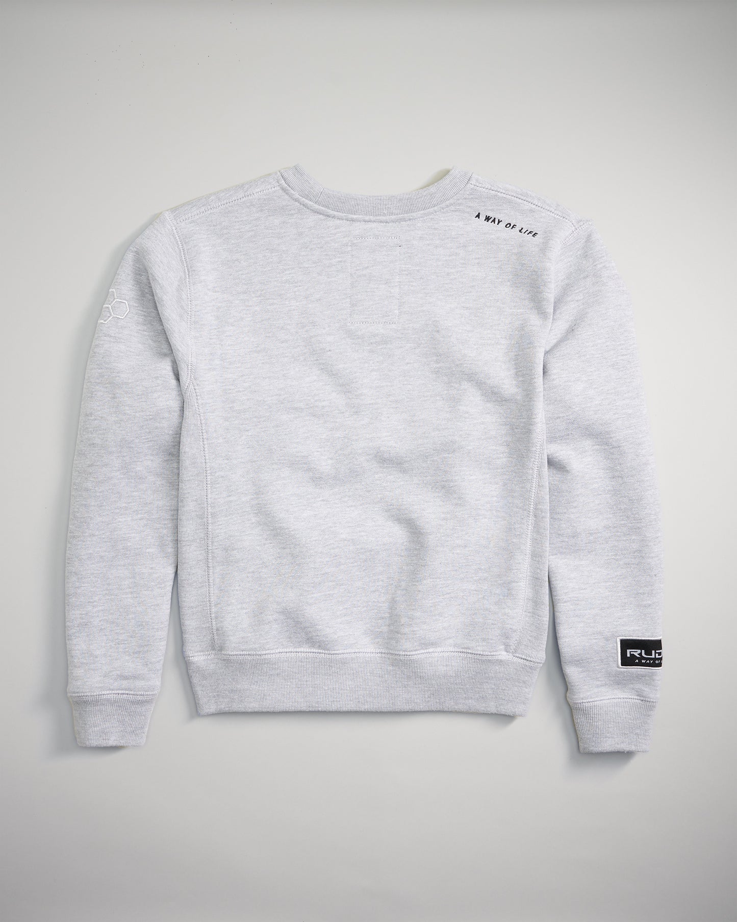 A gray crewneck sweatshirt featuring minimalistic design elements including an embroidered logo and text on the back suitable for casual wear