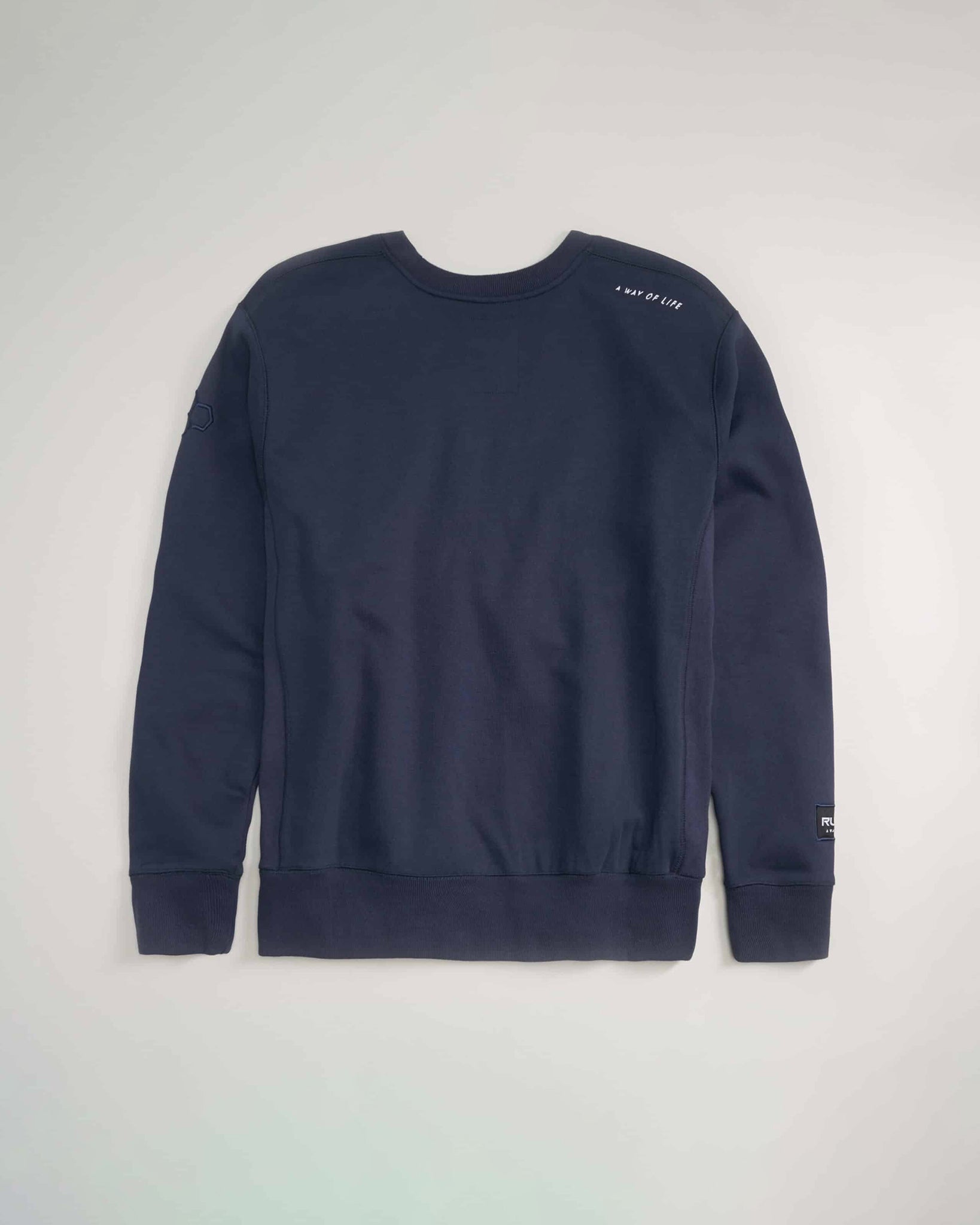 A dark navy crewneck sweatshirt featuring minimalistic design elements including a subtle logo and text printed on the shoulder ideal for casual and comfortable wear