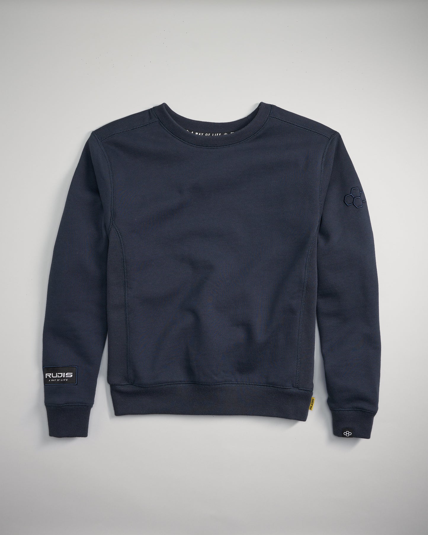 This image features a navy blue sweatshirt with a classic crew neck design and subtle branding details on the sleeves and hem