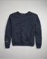 This image features a navy blue sweatshirt with a classic crew neck design and subtle branding details on the sleeves and hem