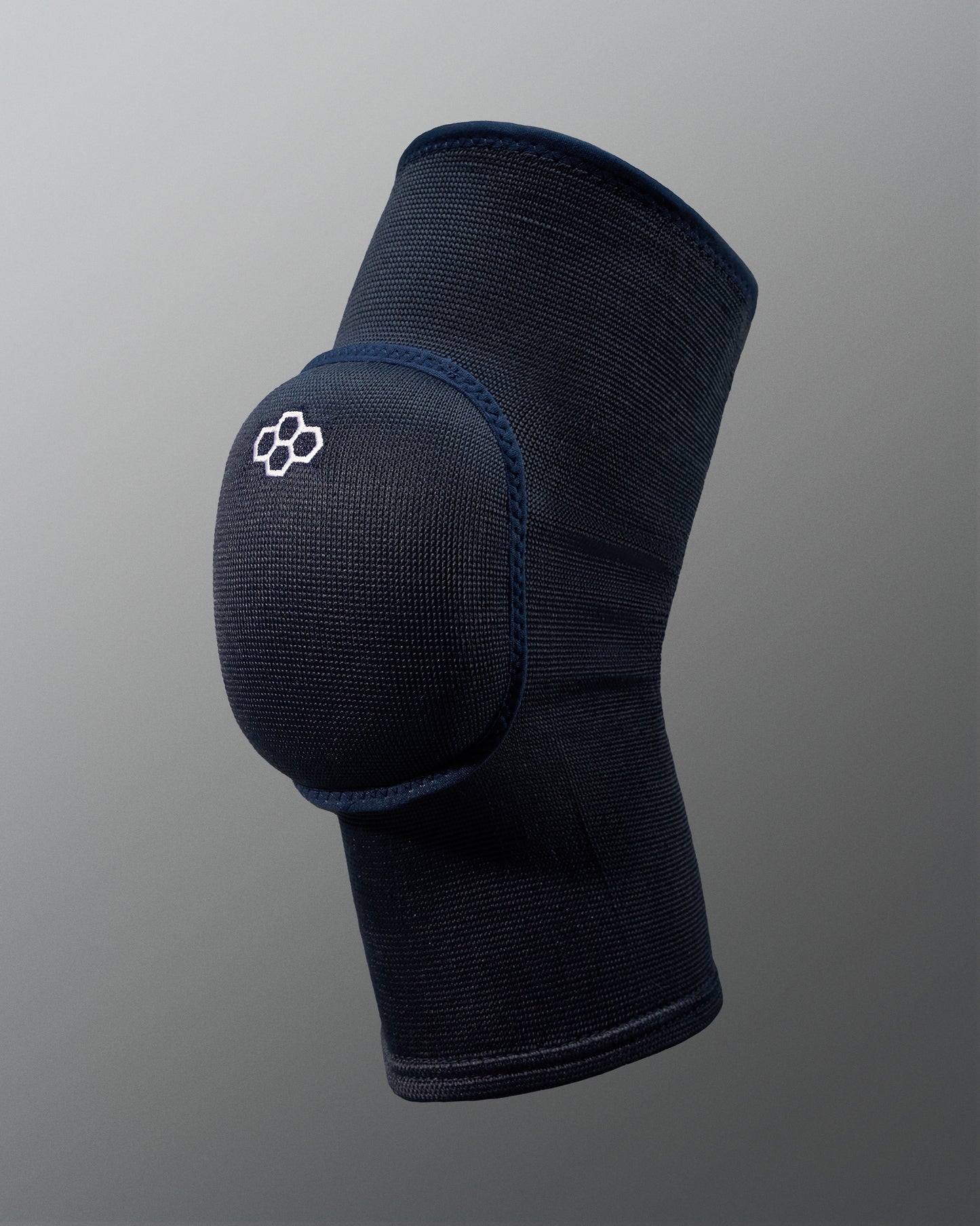 A dark knee support brace designed for injury prevention and rehabilitation featuring a padded area for extra protection