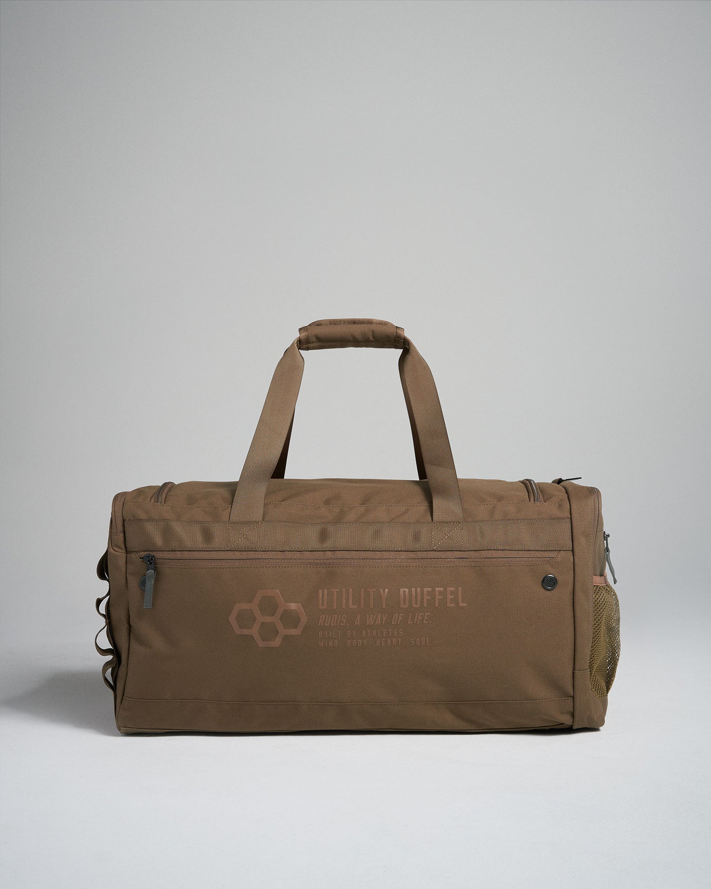 A stylish brown utility duffel bag featuring sturdy handles a zippered closure and a mesh side pocket conveying functionality and modern design