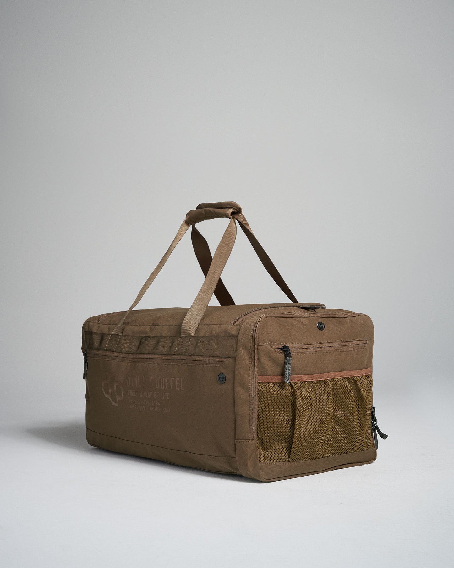 A stylish brown duffel bag made of durable fabric featuring compartments and a comfortable strap for easy transport