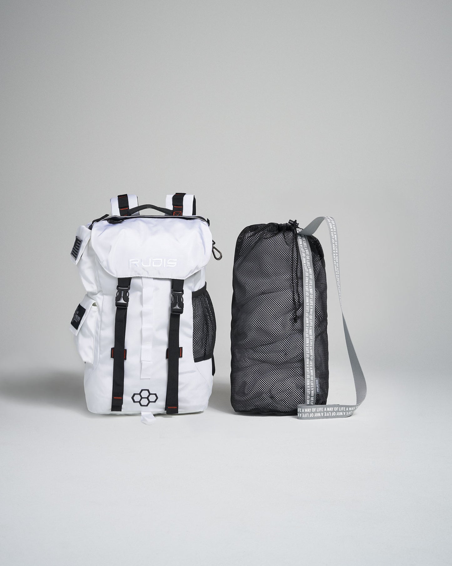 A stylish white backpack alongside a compact black mesh bag showcasing modern design features and functional elements