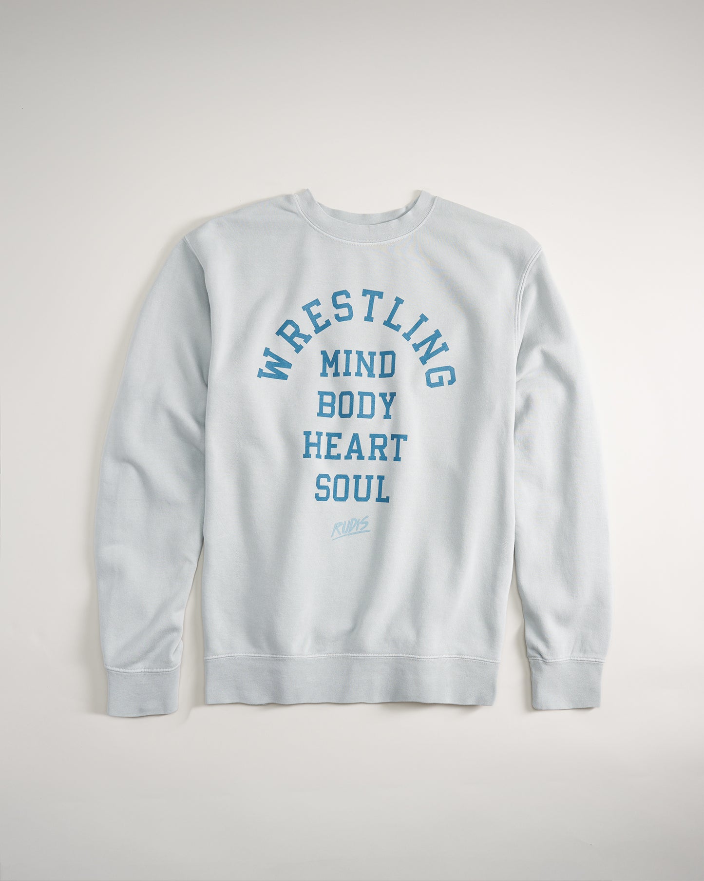 A light blue sweatshirt featuring bold lettering promoting wrestling and its core values: mind body heart and soul