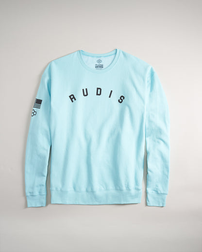 A light blue sweatshirt featuring the word RUDIS across the front and an American flag emblem on the sleeve