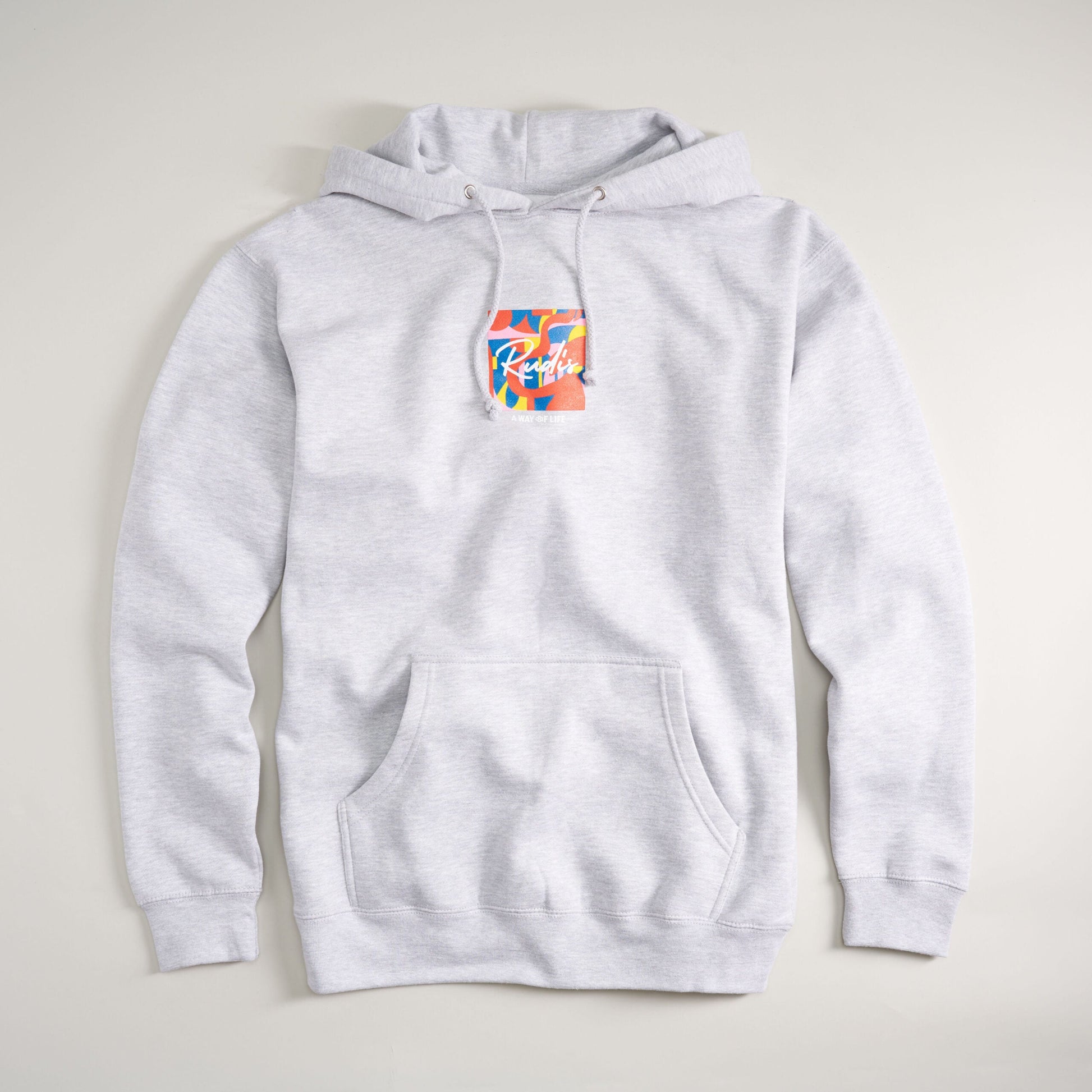 A light gray hoodie featuring a colorful graphic patch on the front with a spacious kangaroo pocket and drawstrings at the hood