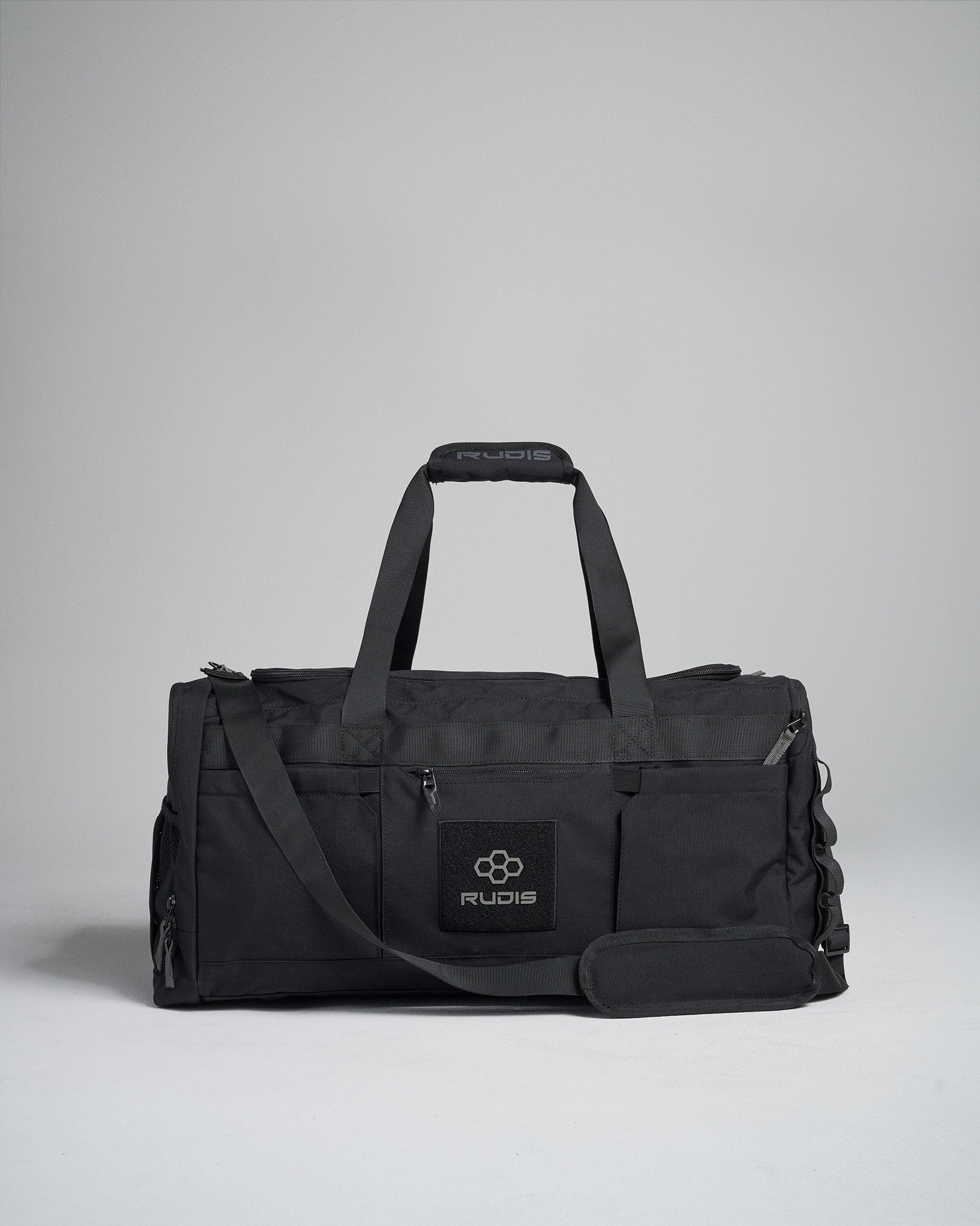 A sleek black gym bag from RUDIS featuring multiple compartments and a durable exterior ideal for athletic activities