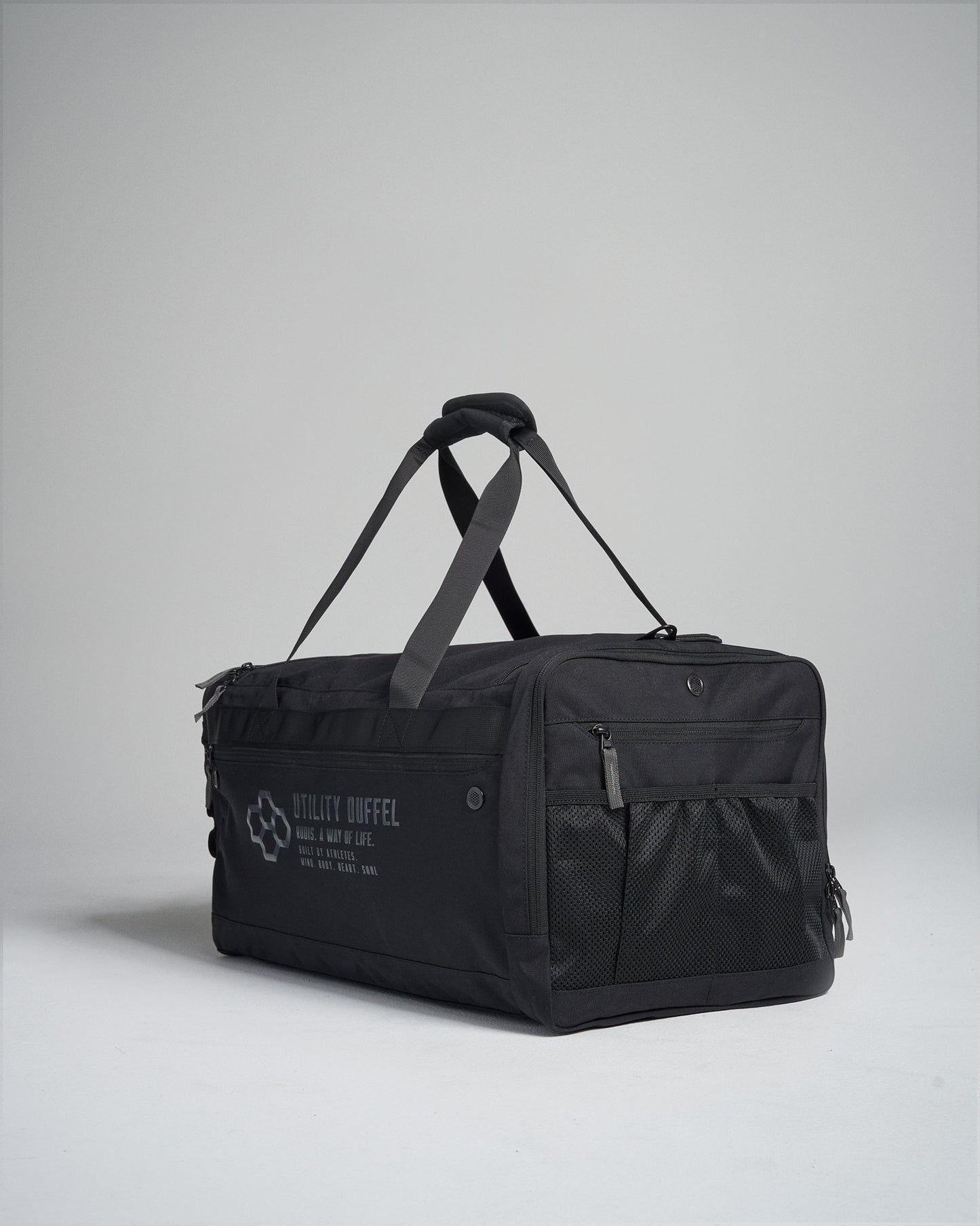 A sturdy black utility duffel bag with adjustable straps and a zippered compartment designed for practical use and versatile storage