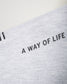 A close-up view of a gray fabric featuring the phrase A WAY OF LIFE printed in bold black letters showcasing the texture and stitching of the material