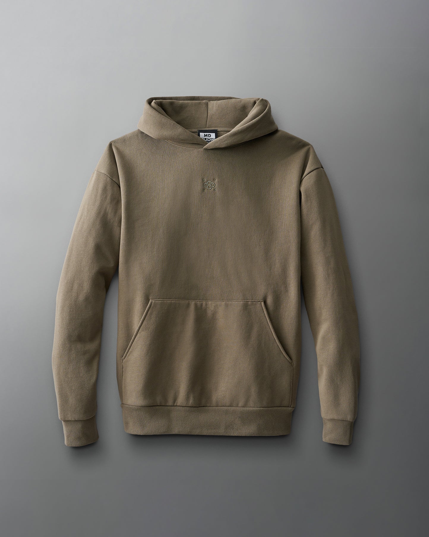 A green hoodie with a front pocket and a small chest logo, crafted from soft material, features fitted sleeves and a ribbed hem, presented against a smooth gray background.