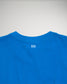 A vibrant blue t-shirt featuring a minimalistic white logo on the back near the collar