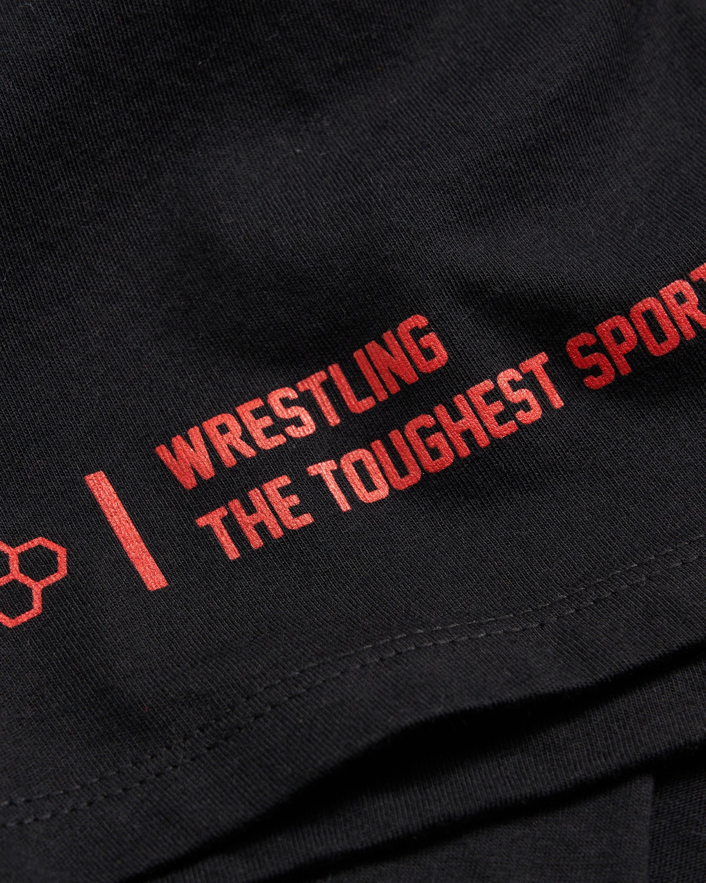 A black t-shirt featuring bold red text that reads WRESTLING THE TOUGHEST SPORT