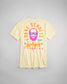 A light yellow t-shirt featuring a vibrant graphic design of a man with sunglasses and a beard along with the text DAVE SCHULTZ 1984 Los Angeles CHAMPION