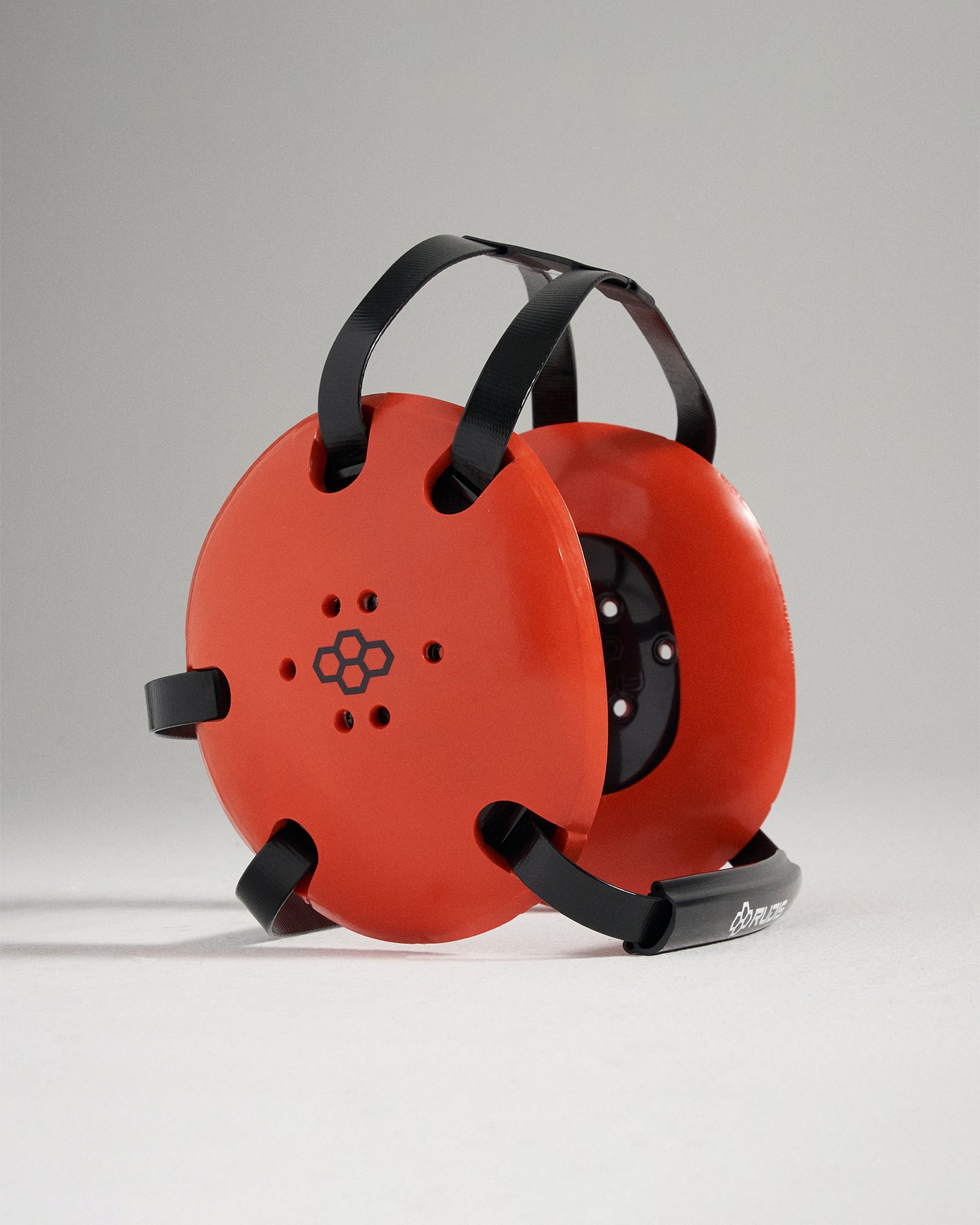 This image features a bright orange circular device designed for a specific athletic or exercise purpose showcasing its unique design and functionality