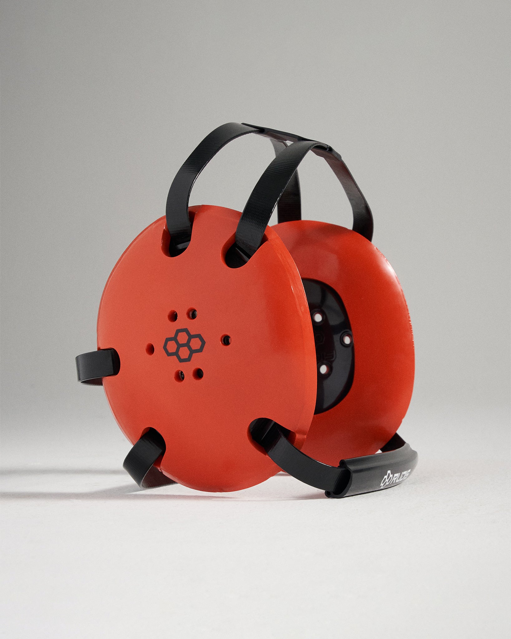 This image features a bright orange circular device designed for a specific athletic or exercise purpose showcasing its unique design and functionality