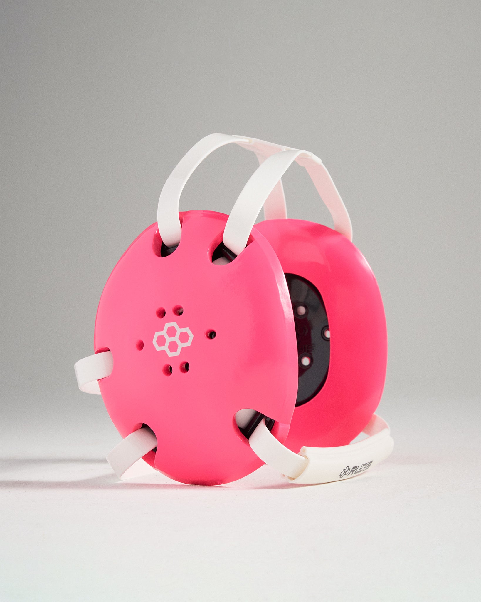 A vibrant pink protective helmet designed for childrens activities features adjustable straps and ventilation holes for comfort and safety