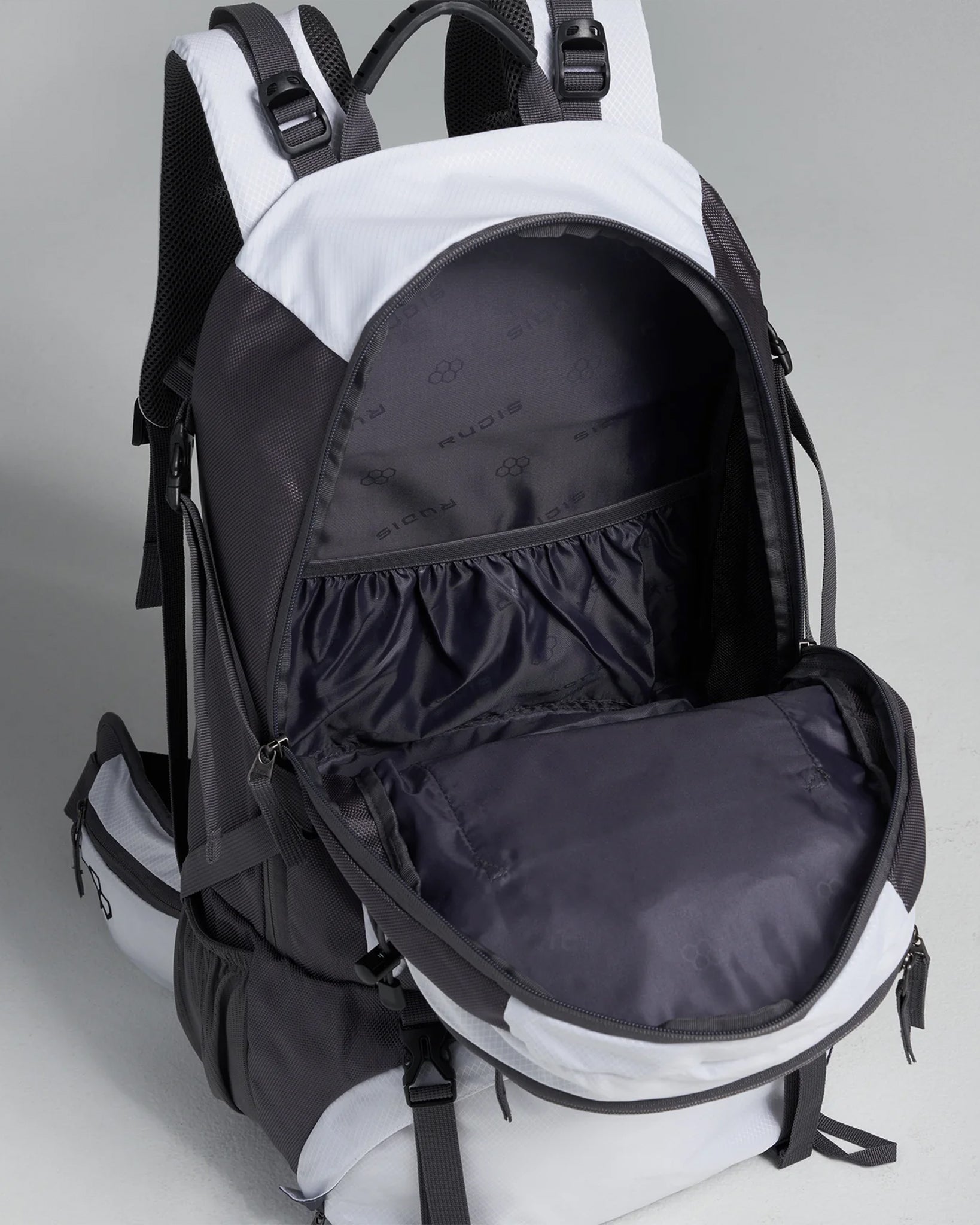 A sleek black and white multifunctional backpack featuring a spacious interior and various compartments for organization