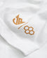 A close-up of a white fabric featuring a stylish gold logo and numbers showcasing contemporary branding design