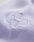 A close-up view of a light lavender fabric featuring a subtle embroidered hexagonal pattern