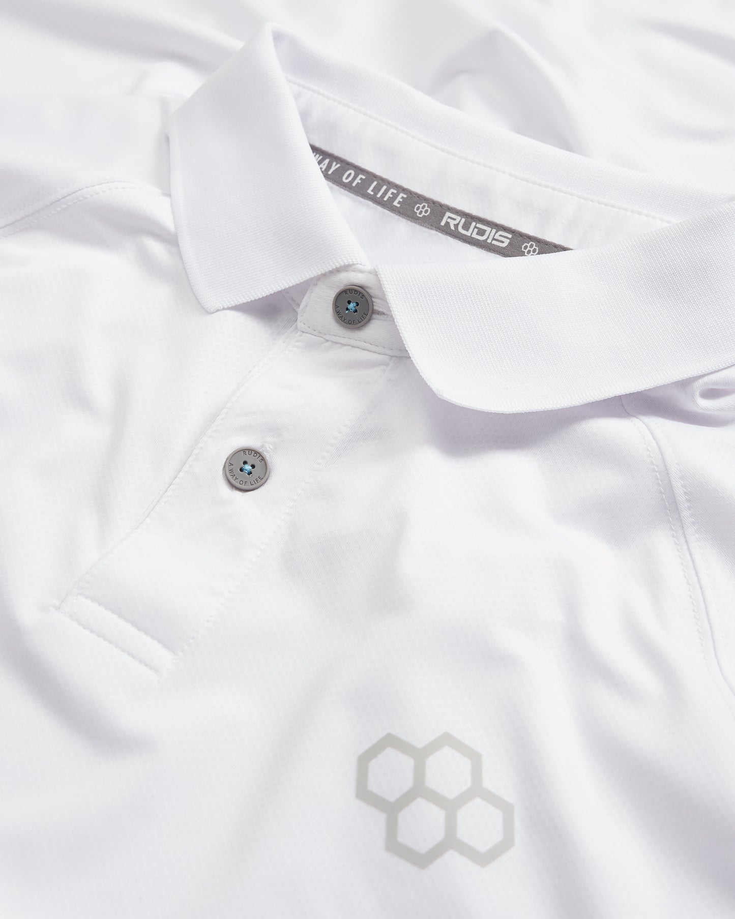 A close-up view of a white polo shirt featuring a sleek design with a subtle logo and contrasting buttons