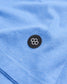 A close-up view of a blue fabric featuring a circular black patch with a geometric design of interconnected hexagons