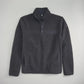 This image displays a cozy black pullover made from soft fleece material featuring a quarter-length zipper and a chest pocket with a button closure