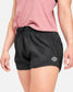 This image features a close-up of a person wearing stylish black athletic shorts paired with a pink top highlighting the shorts modern design and functionality