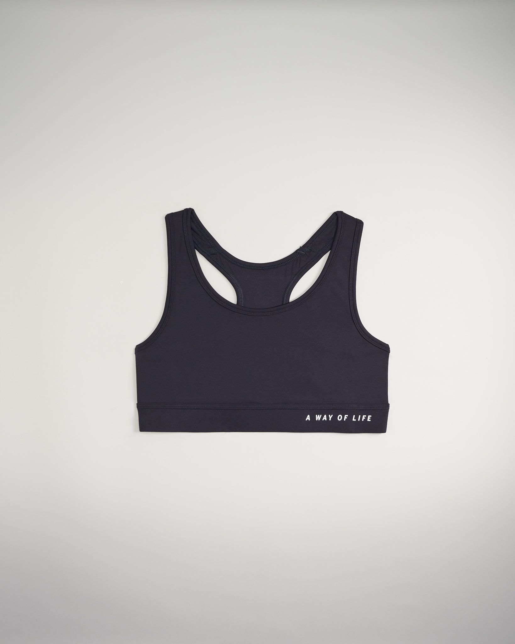 A sleek black sports bra featuring a racerback design and a motivational slogan printed on the band ideal for activewear and fitness enthusiasts