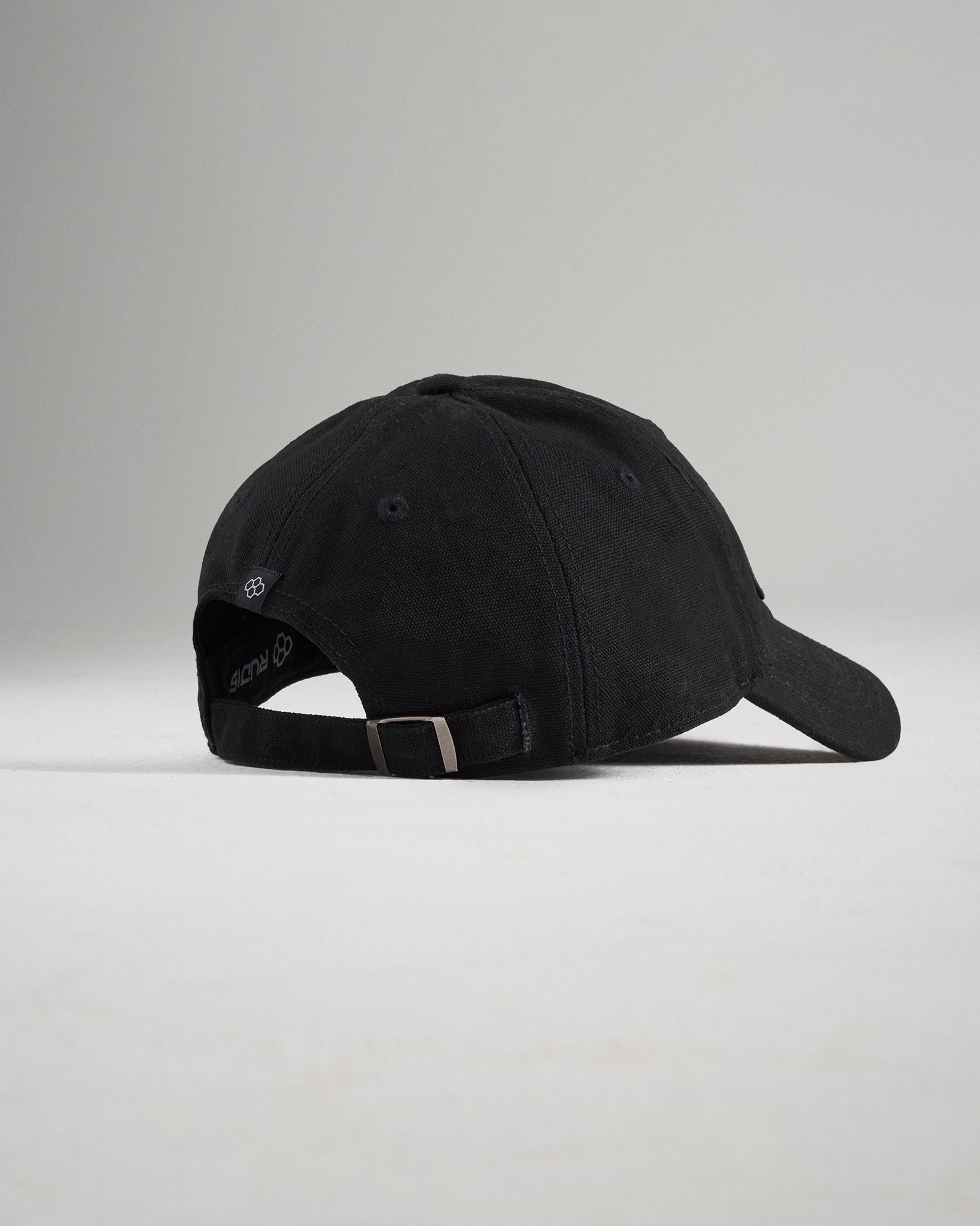 A black baseball cap with a curved visor and adjustable strap showcasing a simple modern design suitable for casual wear