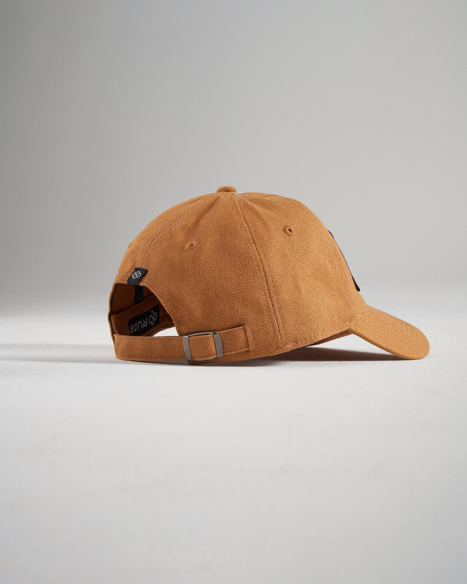 A stylish tan baseball cap featuring a curved brim textured fabric and adjustable strap ideal for casual wear