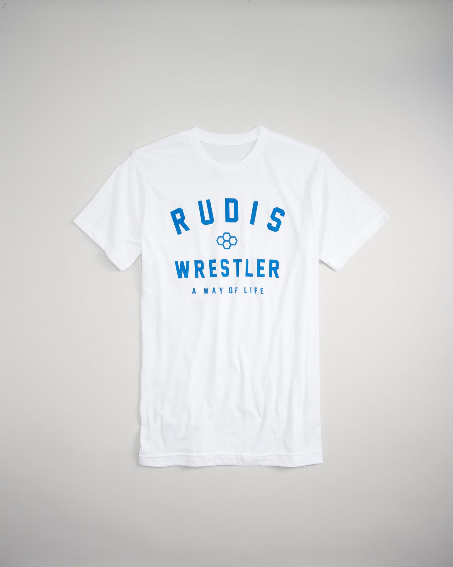 A white t-shirt featuring bold blue text that reads RUDIS WRESTLER A WAY OF LIFE