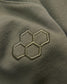 Embroidered hexagonal pattern on olive green fabric highlighting a stylish and modern design element