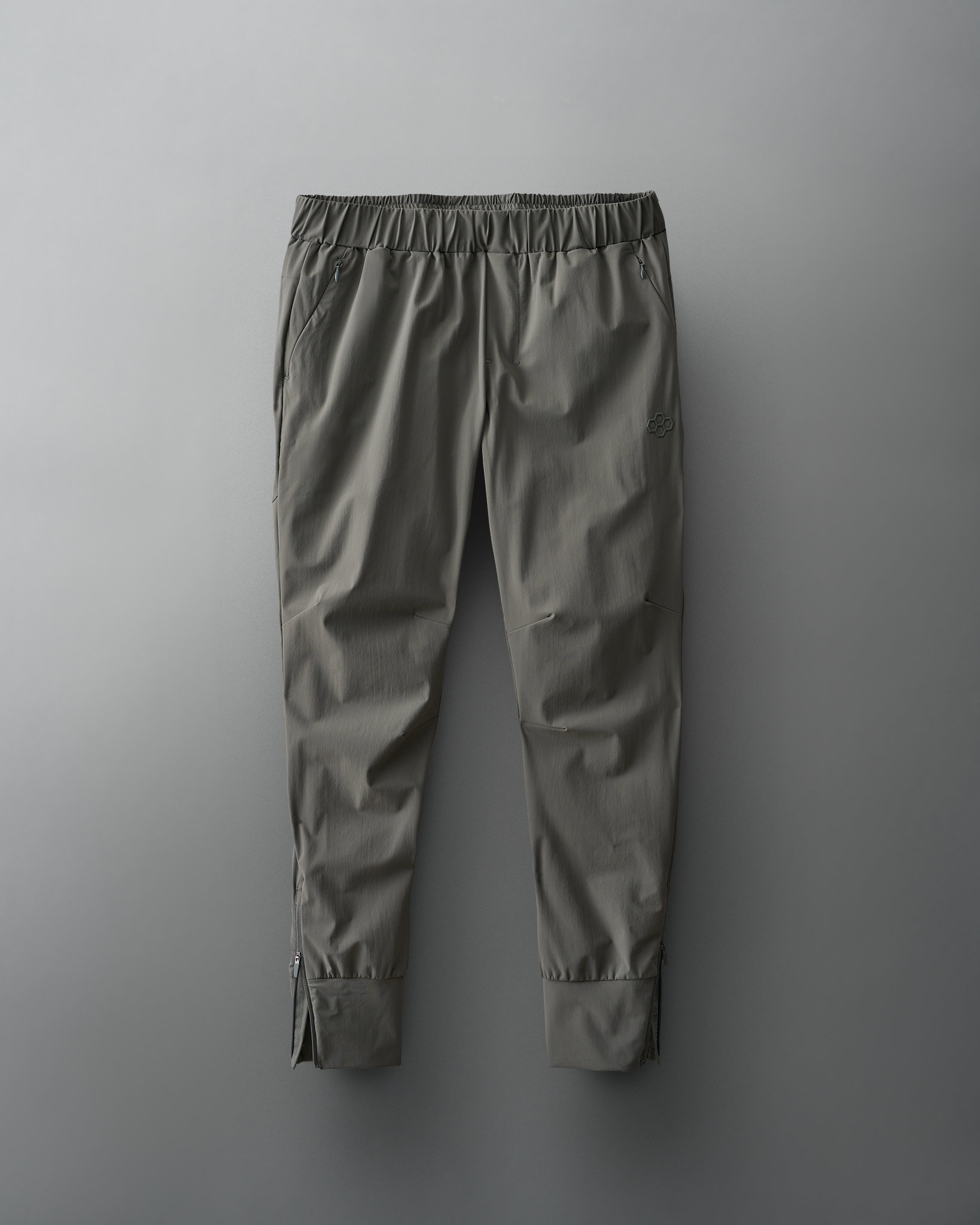 Lightweight dark gray athletic pants with an elastic waistband and zippered pockets for secure storage, featuring a tapered design suitable for workouts.