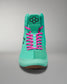 A vibrant turquoise high-top sneaker with neon pink laces and a black logo, showcased against a neutral gray background.