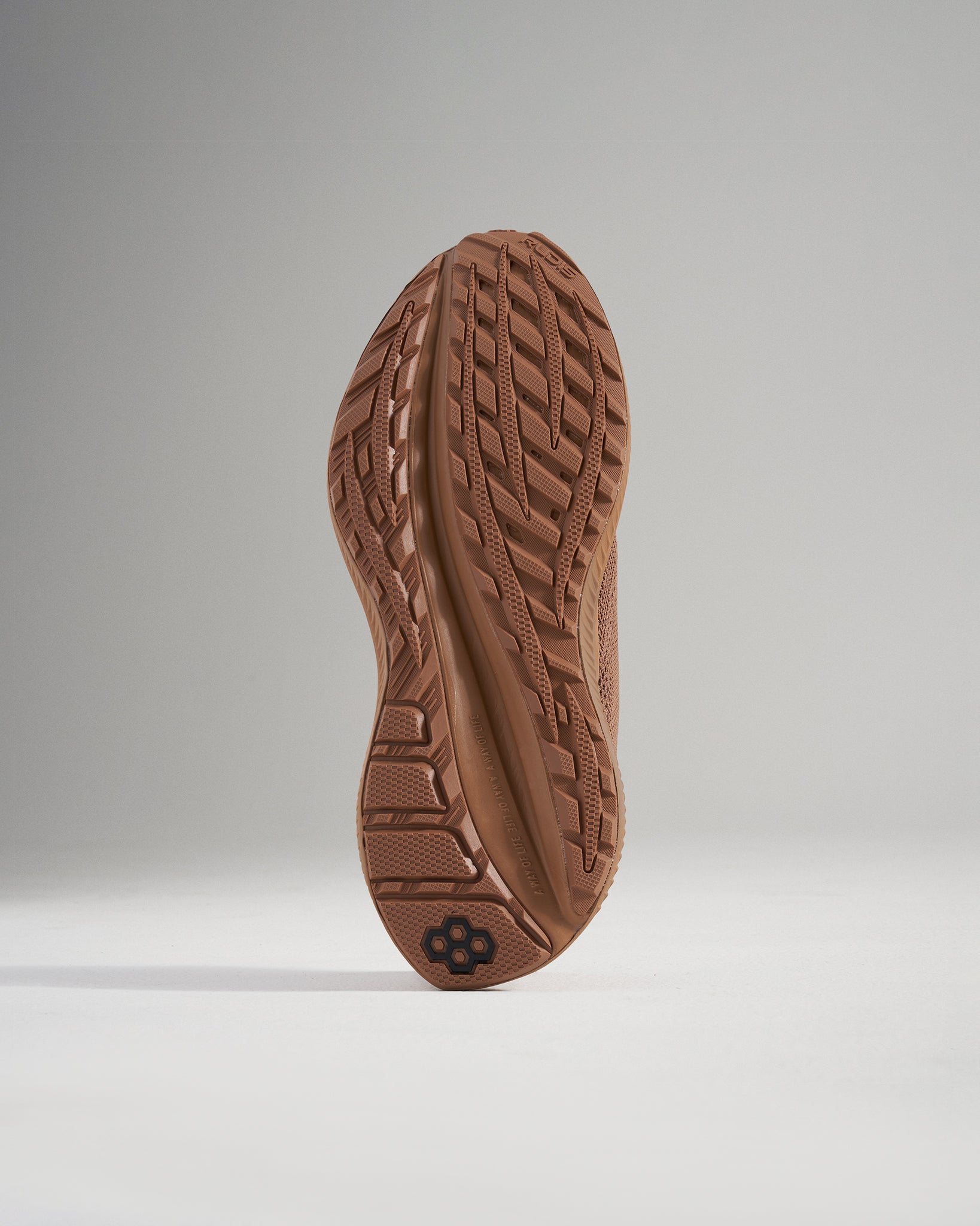 The image showcases the intricate tread design of a brown athletic shoes sole emphasizing its grip and durability