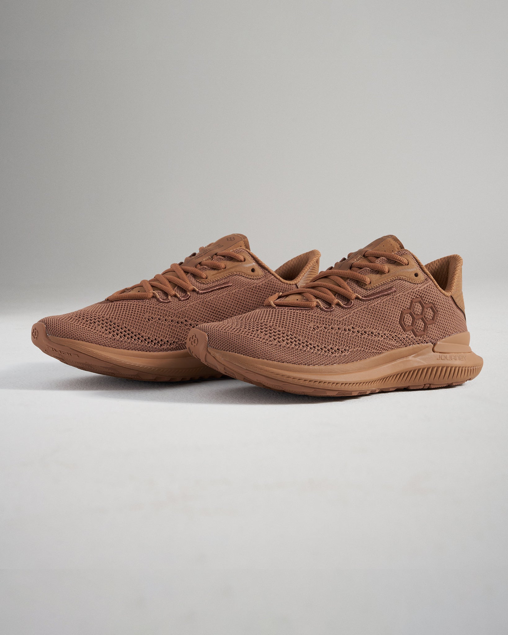 These lightweight brown athletic shoes feature a breathable mesh design perfect for running and casual wear